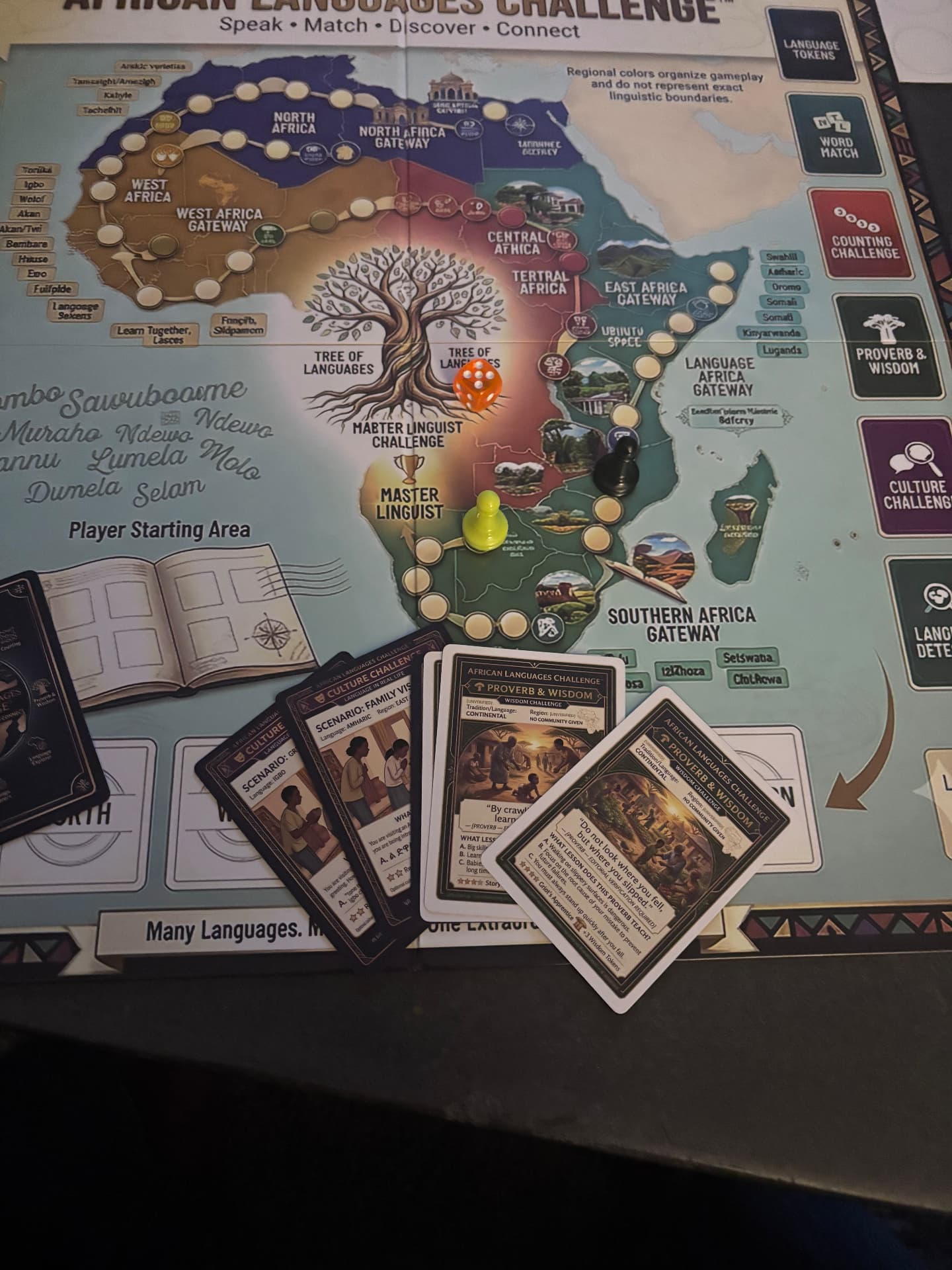 African Languages Challenge board in play with Africa map, pawns, dice, cards, and language challenge spaces